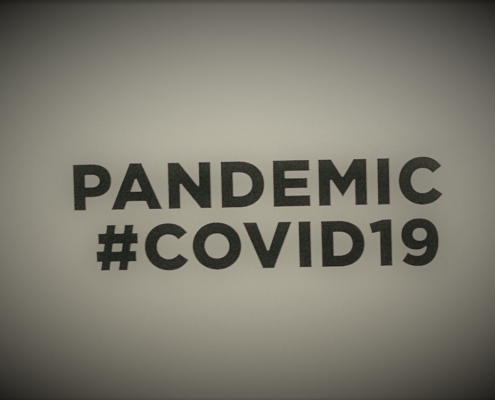 Canva – People Holding A Placard With Pandemic Covid19 Text