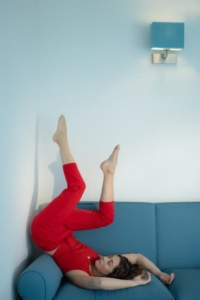 canva-person-in-red-pants-lying-on-blue-couch-MAES0kqFccU